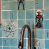 Detail image of Tortuga Tile Works custom hand-made ceramic Atomic back splash featuring iconic lithium atoms and robots. Photo by Lee Sandweiss
