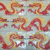 Image showing hand-made Ceramic Tortuga Tile border featuring red and yellow Chinese dragons with a grey background. Six inch tiles, One head, one tail and one middle section that can repeat as needed. Left and right facing dragons available.