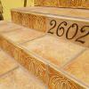 Image showing hand-made Ceramic Tortuga Tile step risers and address number tile.
Tiles are cream and ochre with an art deco design. 6" x 8" and 5" x 8".